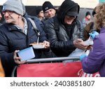 Small photo of Krakow, Poland - Dec 17, 2023: Christmas Eve for poor and homeless on the Main Square in Cracow. The group Kosciuszko prepares the greatest eve in the open air in Krakow