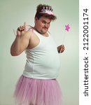 Small photo of I've got something for you. Shot of an obese man wearing a fairy costume.