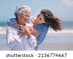 Small photo of Taking time out to show some tenderness. Shot of a beautiful young woman and her senior mother on the beach.
