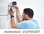 Small photo of Handymen are always handy to have around. Shot of a mature man installing a security camera on a building.
