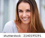Smilling can be contagious. Portrait of a beautiful woman smiling at the camera.