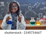 Small photo of Youre never too young to pursue a love for science. Portrait of a little girl in a lab coat doing a science experiment in a lab.