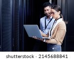No one knows networking like they do. Shot of two technicians working together in a server room.