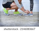 Small photo of Workout chivalry. Shot of a young man tying his girlfriends shoelaces before a workout.