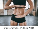 Small photo of You get exactly what you work for. Cropped shot of a woman framing her stomach with her hands.