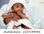 Small photo of A nap is exactly what I need after that bath. Shot of an adorable baby boy wrapped in a bath towel.