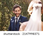Small photo of Shes the most beautiful woman hes ever set his eyes on. Cropped shot of an affectionate young bridegroom smiling at his bride while standing outdoors on their wedding day.