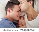 Small photo of Hes my better half. Shot of a young gay couple relaxing in bed.