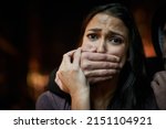 Small photo of Defenceless and in danger. Portrait of a frightened young woman with her assailants hand over her mouth.