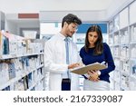 Small photo of Hes always willing to offer some of his expert advice. Shot of a pharmacist assisting a customer in a pharmacy.