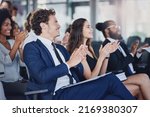 Small photo of They dont just applaud for anything. Low angle shot of a group of businesspeople applauding during a seminar in the conference room.