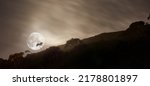 Small photo of Landscape view of smoke from uncontrollable wildfire or bush fires rolling over Table Mountain Nature Reserve, South Africa. Fog, mist and moon over remote countryside hill with copy space at night