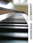 Small photo of Ivory and ebony piano keys on musical instrument used by musician to create and play relaxing symphony or classical song. Closeup and macro detail of creative talent equipment in home or music school