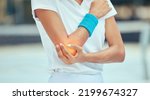 Small photo of Tennis elbow, pain and injury with a sports woman holding her joint during training, workout and exercise. Fitness, health and accident with a female athlete in a game or match on a court outside