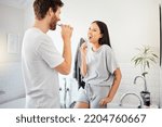 Small photo of Love, morning and couple in bathroom brushing teeth together doing daily routine, happy and smile. Man and woman with good dental health, mouth care and cleaning teeth with toothbrush and toothpaste