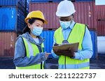 Covid, documents and supply chain logistics with a team working in shipping on a commercial container dock. Teamwork, freight and cargo with a man and woman courier filling out an order or shipment