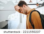 Small photo of Burnout, depression or mental health with man student from anxiety or exam stress for education, college or university. Sad, headache or scared male thinking about fail, problem or project deadline
