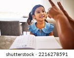 Small photo of Education, homeschool and a kindergarten girl with smile, notebook and help from mother in math class. Home school, happy child and learning to count on fingers and hands, woman teaching kid maths.