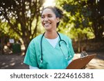Woman, nurse and smile with clipboard in the park for healthcare, medical or consultation and assistance. Happy female doctor or veterinary in nursing check, inspection or prescription advice outside
