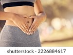 Small photo of Weightloss, hands and heart shape on stomach for body positivity during diet, exercise and training. Wellness, health and closeup of woman with self love gesture on tummy while doing outdoor workout.