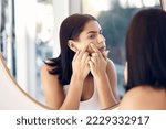 Small photo of Acne, squeeze and woman in mirror of bathroom for facial, skincare and cleaning with morning routine. Dirt, scar and scratch with girl at home popping and check pimple for problem, blackhead and flaw