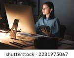 Night office, computer and business woman with tablet for digital marketing, seo analytics and multimedia application review. Website design, graphic designer and creative employee in dark workspace