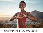 Small photo of Black woman, fitness and heart hands on mountain with music for outdoor sports motivation portrait, travel exercise and freedom. African woman, happy athlete and love sign for hiking with podcast