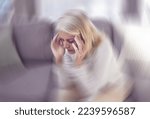 Senior woman, headache and sofa in home with motion blur, pain and depressed while tired in retirement. Elderly, old woman and anxiety with burnout, depression and panic attack on couch at house