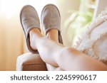 Legs, relax and woman in slippers on sofa resting on weekend at home. Shoes, freedom and female relaxing, lying and spending time alone on comfy, cozy and comfortable couch in living room of house.