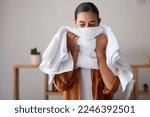 Laundry, fresh and woman smelling a towel after cleaning, housework and washing clothes in the morning. Chores, housekeeping and cleaner with smell of clean clothing after a routine wash at home