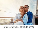Small photo of Yacht, travel and love with a mature couple sitting together on a boat out at sea for a romantic date. Luxury, ocean or summer with a married man and woman on a ship to relax during a trip