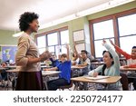 Small photo of School, teacher and children raise their hands to ask or answer an academic question for learning. Diversity, education and primary school kids speaking to their woman educator in the classroom.