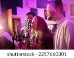 Woman, face or singing group on neon studio microphone in backup singers album, song lyrics or radio recording. Artist, musician or friends in production sound, voice media or light label performance