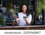 Small photo of Woman, phone and credit card with smile for ecommerce, online shopping or purchase at coffee shop. Happy female customer on smartphone for internet banking, app or wireless transaction at cafe