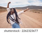 Freedom, excitement and mockup with a black woman dancing in the desert for fun during a road trip. Travel, dance and mock up with a young female enjoying her holiday or vacation outside in nature