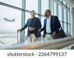 Small photo of Travel for business, team at airport and men, catch flight for work trip with conference or training seminar with accountant. Walk, talk and diversity with finance convention and partnership