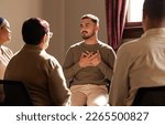 Small photo of Support, trust and man sharing in group therapy with understanding, feelings and talking in session. Mental health, addiction or depression, men and women with therapist sitting together for healing.