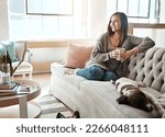 Small photo of Relax, morning tea and woman with dog on a home living room couch feeling calm with happy lifestyle. Happiness and smile of person with puppy thinking with coffee on peaceful lounge day in a house