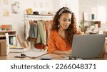 Small photo of Clipboard, laptop and black woman writing in clothing store working on sales or delivery. Fashion, manager and worker in South Africa in small business, fashion shop and planning schedule on computer