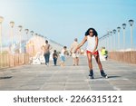 Fresh air and rollerblades is how I start my day. Shot of an attractive young woman rollerblading on a boardwalk.