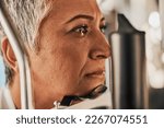 Laser, vision or senior woman in eye exam for eyesight at optometrist office in assessment or consultation. Face of mature female customer testing or checking iris, glaucoma or retina visual health