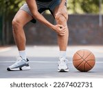 Small photo of Pain, basketball and man with knee injury standing on outdoor court, holding leg. Sports, fitness and athlete with joint pain, injured and hurt in training, workout and game on basketball court