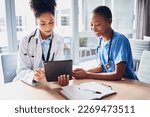 Small photo of Tablet, black woman or doctors with medical research reading news or tests results in hospital together. Teamwork, digital tech or African nurses planning or speaking of healthcare report on website