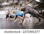 Small photo of People, fitness and side plank in class with personal trainer for workout, stretching exercise or training. Diverse group in warm up stretch session with coach for cardio wellness or balance on floor