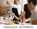 Small photo of Spoilt for choice- it all looks so delicious. A happy couple being served a meat dish at a fine dining restaurant.