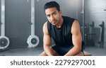 Small photo of Gym, sports man and fitness training by man serious about health, wellness and competitive mindset. Face, portrait and asian instructor sitting before workout, exercise and cardio exercises in Japan