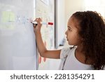 Small photo of Whiteboard, math and girl writing for learning, studying and education in classroom. Development, mathematics and kid or student write equations, numbers and multiplication in elementary school.