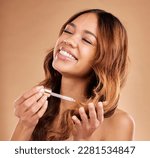 Small photo of Happy woman, hair and oil serum, beauty with cosmetic care and product on studio background. Balayage, split ends treatment with pipette or dropper, cosmetology and female with smile and haircare