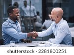 Small photo of Merge with people who match your ambition. two businessmen shaking hands during a meeting.