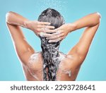 Small photo of Rinsing it out. Shot of an unrecognizable woman washing her hair in the shower against a blue background.